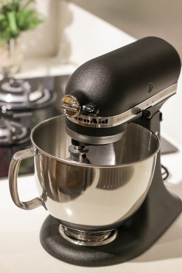 services-04 A stylish black kitchen mixer in a modern kitchen setting, perfect for baking needs.