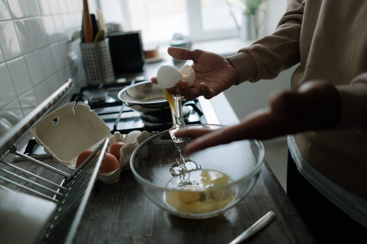 services-02 Hands delicately cracking eggs over a bowl, perfect for cooking and kitchen-themed projects.